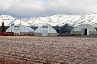 Quonset steel arch machinery storage building on a farm 